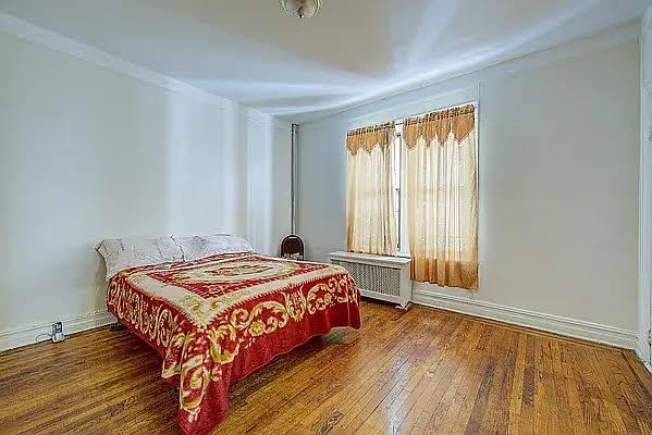 1304 Pacific St Unit B1, Brooklyn, NY 11216 - bedroom with radiator heating unit, wood finished floors, and ornamental molding
