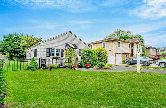 24 Lowerre St, Babylon, NY 11702 - view of front of home featuring an attached garage and asphalt driveway