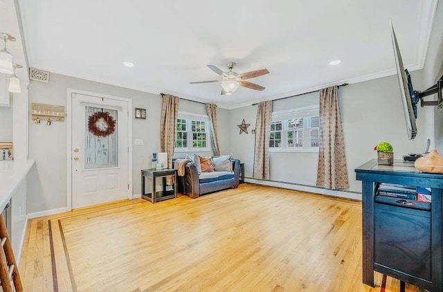 24 Lowerre St, Babylon, NY 11702 - entrance foyer featuring wood finished floors, ceiling fan, a baseboard heating unit, ornamental molding, and recessed lighting