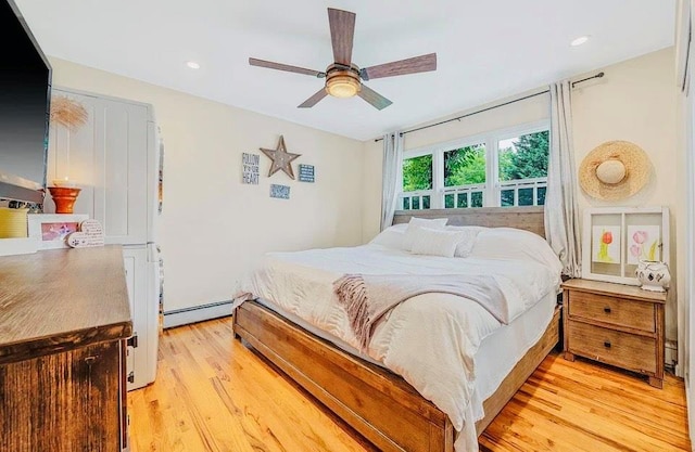 24 Lowerre St, Babylon, NY 11702 - bedroom with light wood-type flooring, a baseboard heating unit, and ceiling fan