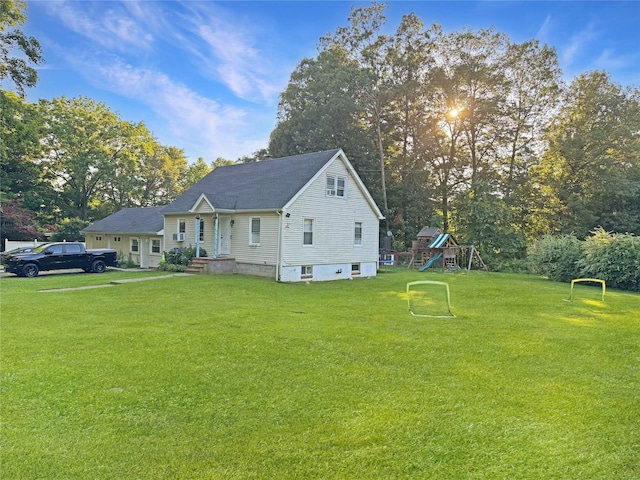41 School St, Cortlandt Manor, NY 10567 - view of side of home featuring a playground, a lawn, and view of wooded area