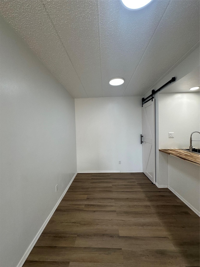 41-28 71st St Unit 4D, Woodside, NY 11377 - basement with a barn door, wood finished floors, recessed lighting, and a textured ceiling