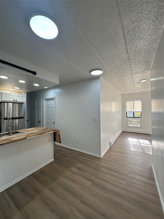 41-28 71st St Unit 4D, Woodside, NY 11377 - unfurnished living room with dark wood-type flooring and baseboards