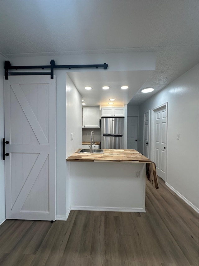 41-28 71st St Unit 4D, Woodside, NY 11377 - kitchen featuring freestanding refrigerator, dark wood-type flooring, butcher block counters, a barn door, and recessed lighting