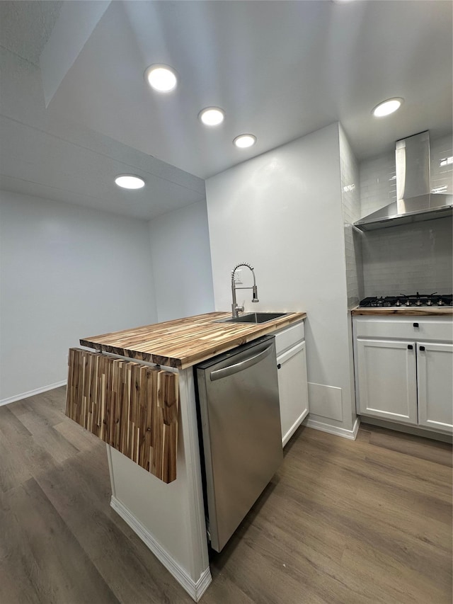41-28 71st St Unit 4D, Woodside, NY 11377 - kitchen with stainless steel appliances, wall chimney range hood, dark wood finished floors, a peninsula, and white cabinets