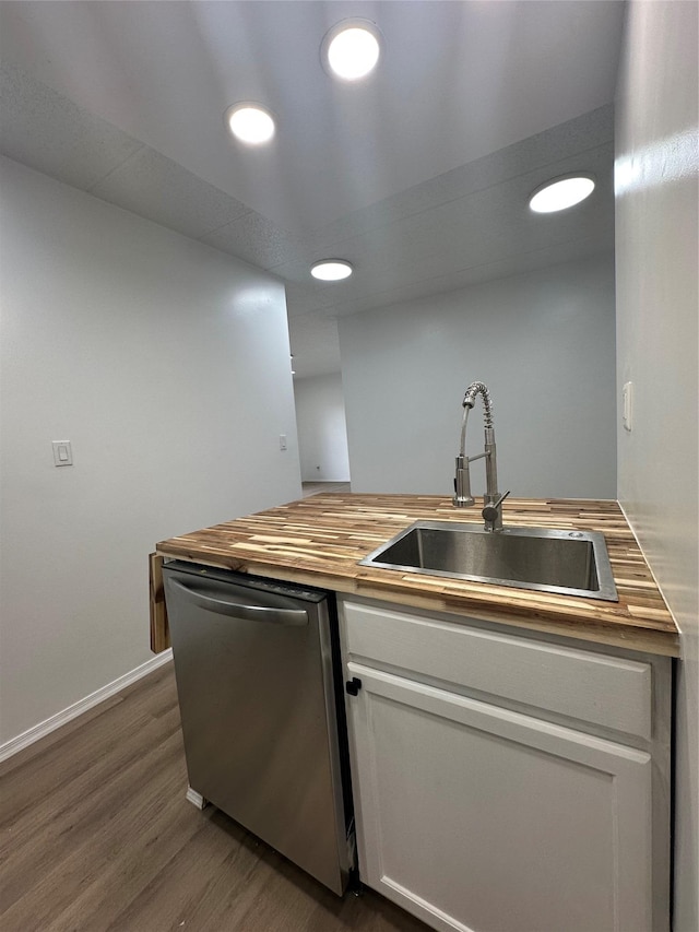 41-28 71st St Unit 4D, Woodside, NY 11377 - kitchen featuring stainless steel dishwasher, butcher block countertops, white cabinets, dark wood-style floors, and recessed lighting