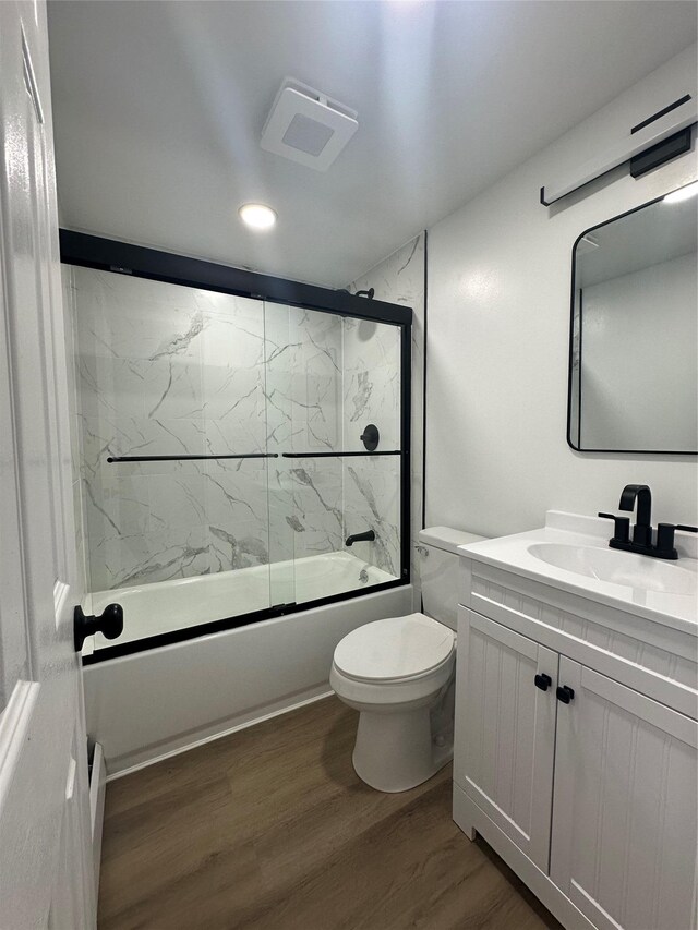 41-28 71st St Unit 4D, Woodside, NY 11377 - bathroom featuring vanity, wood finished floors, shower / bath combination with glass door, and recessed lighting