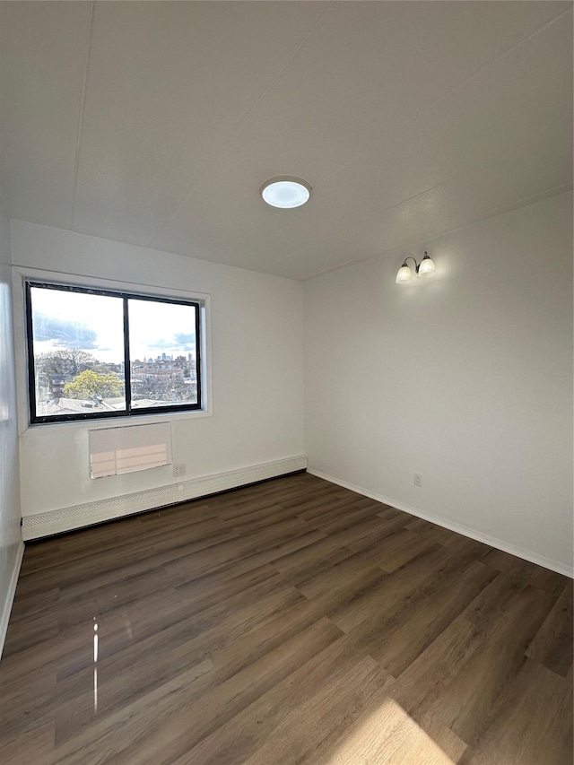 41-28 71st St Unit 4D, Woodside, NY 11377 - spare room with dark wood-style flooring and a baseboard heating unit