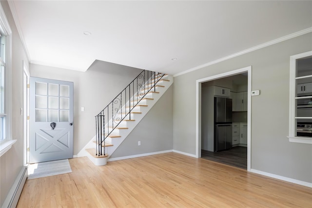 795 Pine Tree Rd, Cutchogue, NY 11935 - foyer with baseboard heating, crown molding, light wood finished floors, and stairs