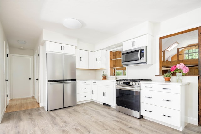 795 Pine Tree Rd, Cutchogue, NY 11935 - kitchen featuring stainless steel appliances, light wood-style floors, light countertops, and white cabinetry