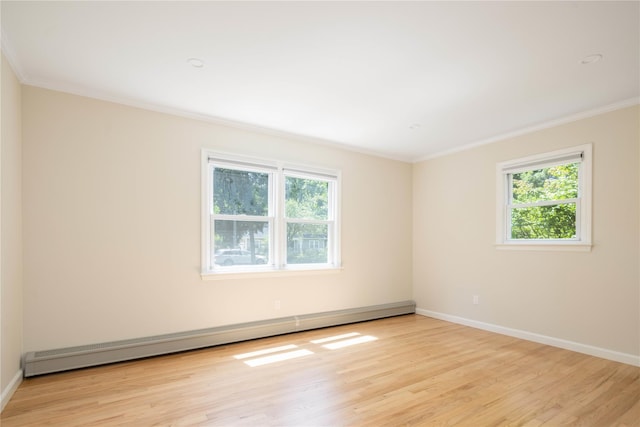 795 Pine Tree Rd, Cutchogue, NY 11935 - unfurnished room featuring ornamental molding, plenty of natural light, baseboard heating, and light wood finished floors