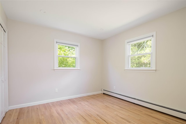 795 Pine Tree Rd, Cutchogue, NY 11935 - unfurnished bedroom with a baseboard heating unit, light wood finished floors, and a closet