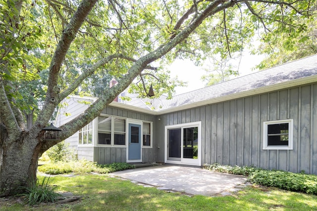 795 Pine Tree Rd, Cutchogue, NY 11935 - back of house with board and batten siding, a patio, and roof with shingles