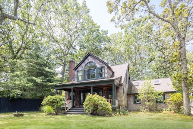 2860 Pine Tree Rd, Cutchogue, NY 11935 - view of front of home with covered porch, a chimney, a front yard, and a shingled roof