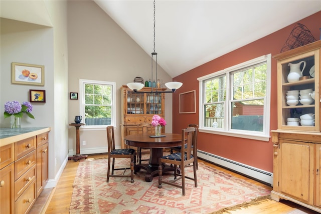 2860 Pine Tree Rd, Cutchogue, NY 11935 - dining space with light wood-type flooring, baseboard heating, healthy amount of natural light, and high vaulted ceiling