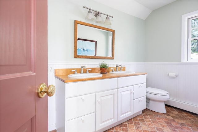 2860 Pine Tree Rd, Cutchogue, NY 11935 - full bathroom featuring double vanity, wainscoting, a baseboard heating unit, and lofted ceiling