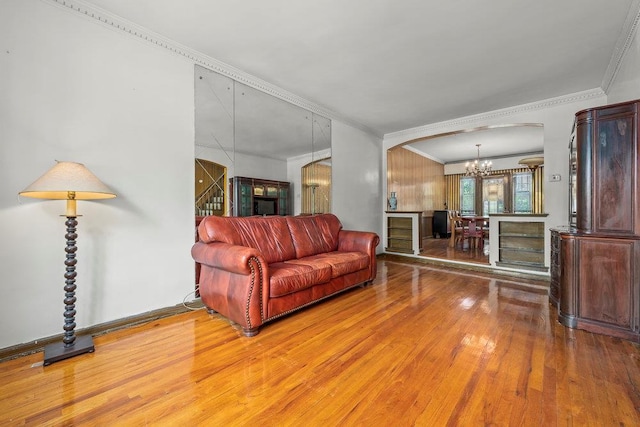 70-40 Utopia Pkwy, Fresh Meadows, NY 11365 - living area with wood finished floors, crown molding, a chandelier, arched walkways, and beverage cooler