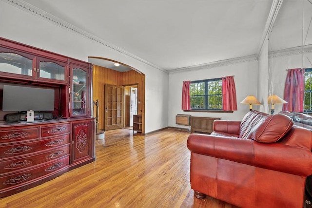 70-40 Utopia Pkwy, Fresh Meadows, NY 11365 - living area with arched walkways, light wood-style floors, ornamental molding, and radiator