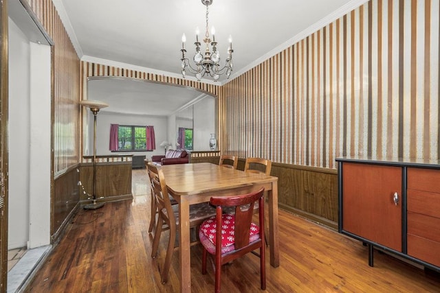 70-40 Utopia Pkwy, Fresh Meadows, NY 11365 - dining space featuring wallpapered walls, wood finished floors, wainscoting, a chandelier, and ornamental molding