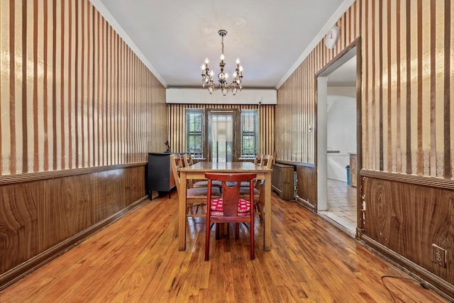 70-40 Utopia Pkwy, Fresh Meadows, NY 11365 - dining area with crown molding, wallpapered walls, wood finished floors, and a chandelier