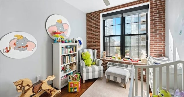4260 Crescent St Unit 10C, Long Island City, NY 11101 - living area featuring wood finished floors and brick wall