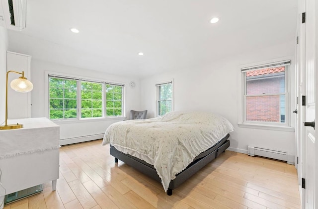 39-12 215th Pl, Bayside, NY 11362 - bedroom with a baseboard heating unit, light wood-style flooring, and recessed lighting