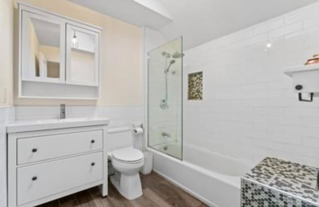 39-12 215th Pl, Bayside, NY 11362 - bathroom featuring vanity, wood finished floors, and shower / tub combination