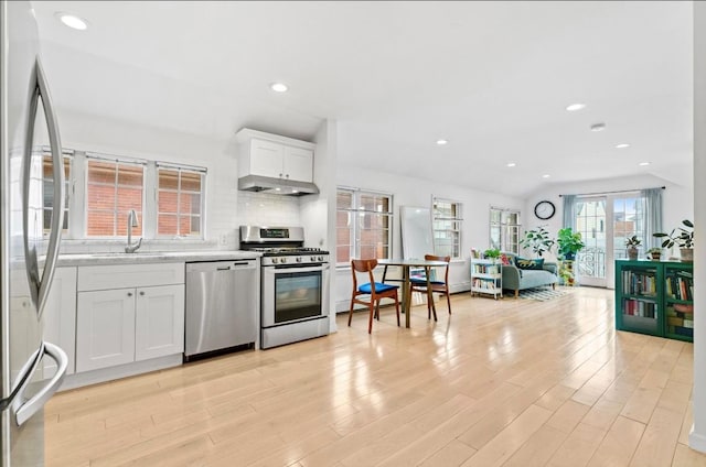 39-12 215th Pl, Bayside, NY 11362 - kitchen featuring appliances with stainless steel finishes, light wood finished floors, white cabinets, under cabinet range hood, and recessed lighting