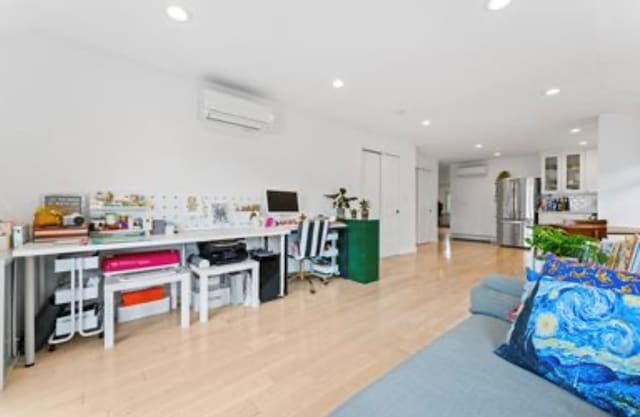 39-12 215th Pl, Bayside, NY 11362 - recreation room featuring recessed lighting, light wood-type flooring, and an AC wall unit