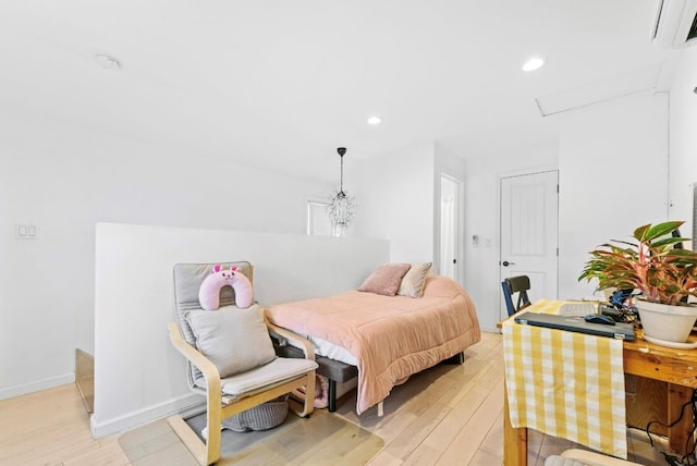 39-12 215th Pl, Bayside, NY 11362 - bedroom with light wood-style floors, a wall mounted air conditioner, and recessed lighting