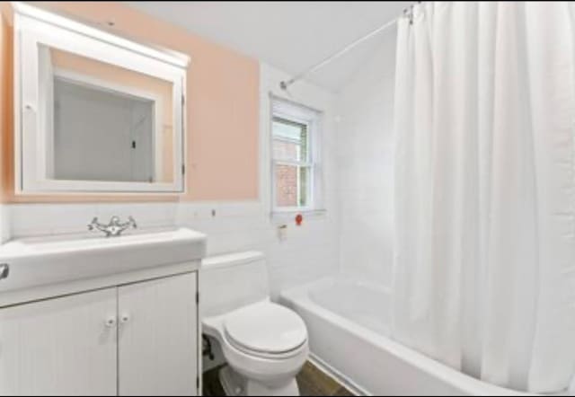 39-12 215th Pl, Bayside, NY 11362 - full bathroom with vanity, shower / tub combo with curtain, wainscoting, and tile walls