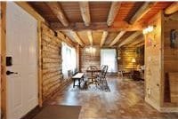 733 Braden Rd, Wawarsing, NY 12435 - dining space featuring a wooden ceiling with exposed beams and rustic walls