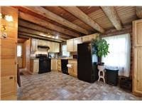 733 Braden Rd, Wawarsing, NY 12435 - kitchen featuring a wood ceiling with exposed beams and freestanding refrigerator