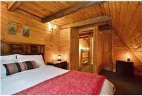 733 Braden Rd, Wawarsing, NY 12435 - bedroom featuring a wooden ceiling with exposed beams and log walls