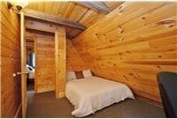 733 Braden Rd, Wawarsing, NY 12435 - bedroom with wood ceiling and rustic walls