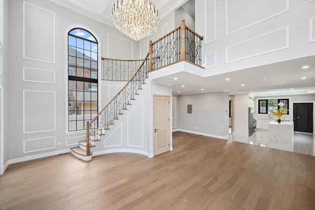 35-26 221st St, Bayside, NY 11361 - foyer featuring a high ceiling, a chandelier, light wood-style floors, stairs, and recessed lighting
