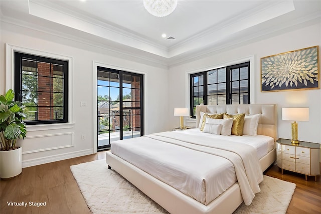 35-26 221st St, Bayside, NY 11361 - bedroom with a tray ceiling, access to exterior, ornamental molding, and wood finished floors
