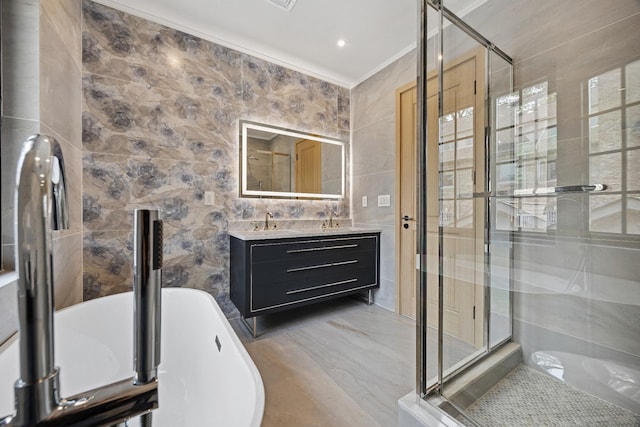 35-26 221st St, Bayside, NY 11361 - bathroom with tile walls, a freestanding bath, a stall shower, double vanity, and ornamental molding