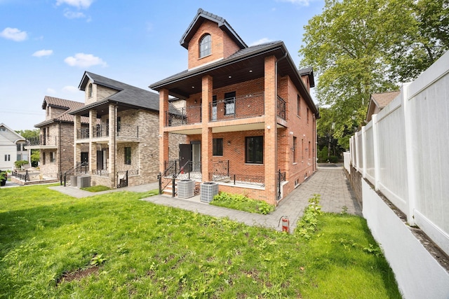 35-26 221st St, Bayside, NY 11361 - back of property with a balcony, brick siding, a fenced backyard, and a patio area