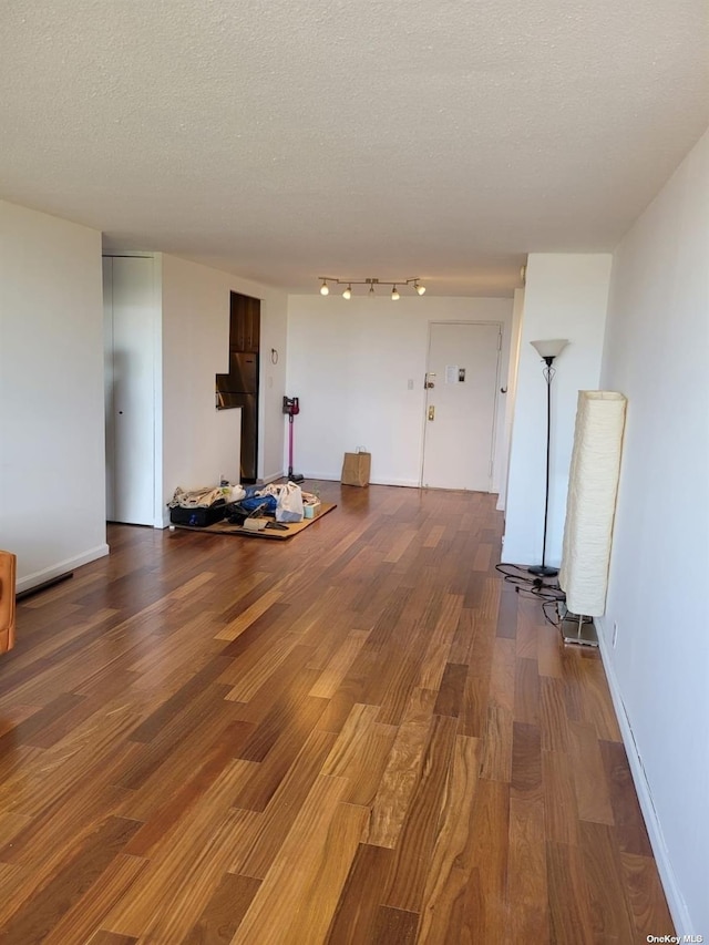 118-17 Union Tpke Unit 14E, Forest Hills, NY 11375 - unfurnished living room featuring wood finished floors and a textured ceiling