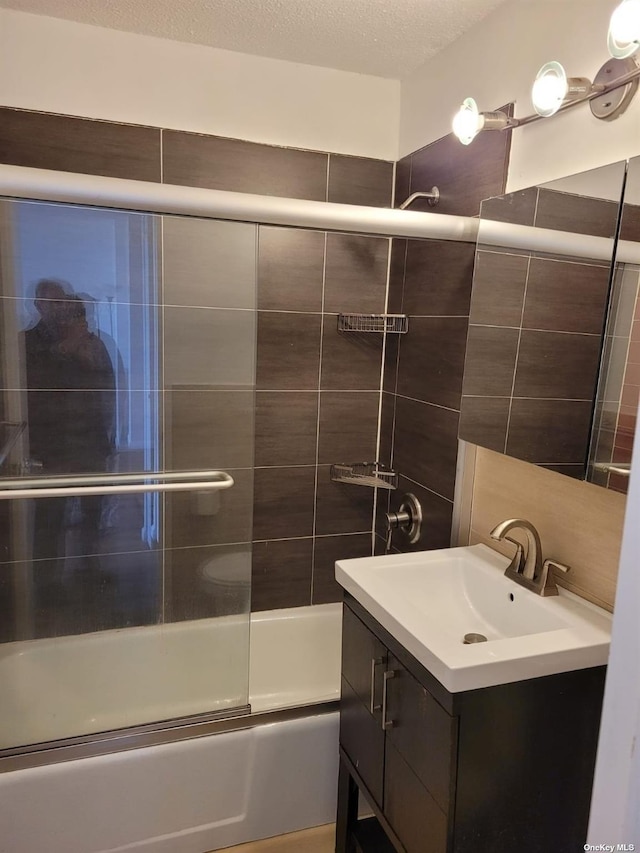 118-17 Union Tpke Unit 14E, Forest Hills, NY 11375 - bathroom featuring combined bath / shower with glass door, vanity, and tile walls