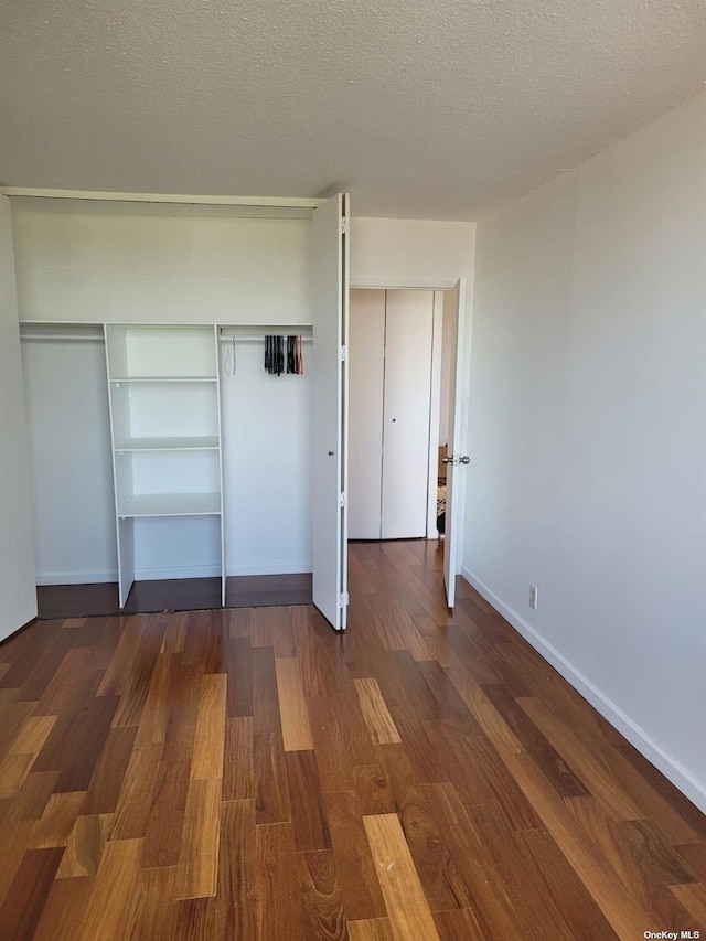 118-17 Union Tpke Unit 14E, Forest Hills, NY 11375 - unfurnished bedroom with wood finished floors, a textured ceiling, and a closet