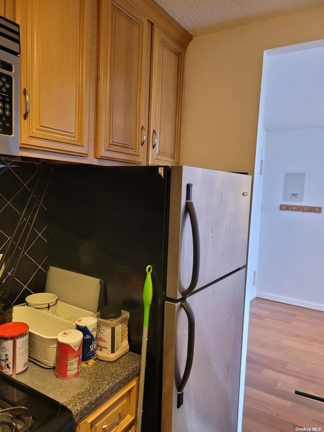 118-17 Union Tpke Unit 14E, Forest Hills, NY 11375 - kitchen featuring range, wood finished floors, and a textured ceiling
