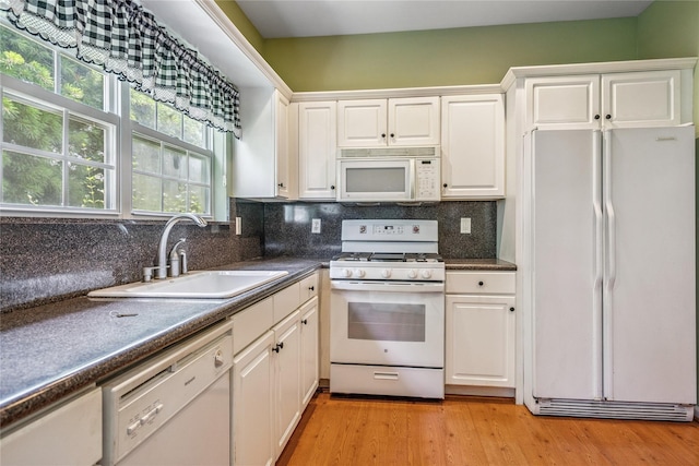 575 Mirror Pond Ct, Moriches, NY 11955 - kitchen featuring white appliances, dark countertops, white cabinetry, and decorative backsplash