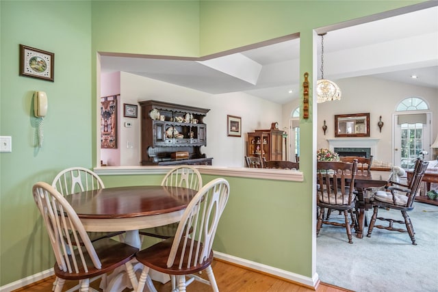 575 Mirror Pond Ct, Moriches, NY 11955 - dining room featuring vaulted ceiling, wood finished floors, and a fireplace