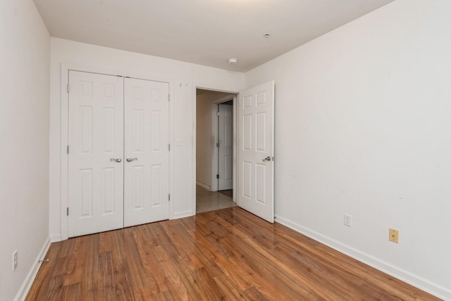 117 Willow Ln, Valley Stream, NY 11580 - unfurnished bedroom featuring wood finished floors and a closet