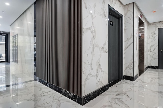14-54 31st Ave Unit 3A, Astoria, NY 11106 - hall featuring stone wall, elevator, recessed lighting, and marble tiled floors