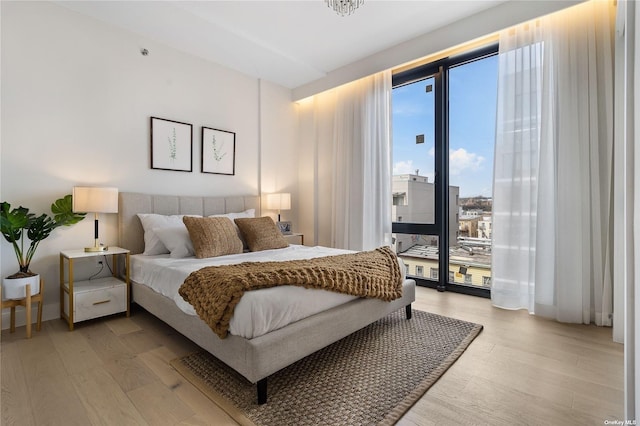 14-54 31st Ave Unit 3A, Astoria, NY 11106 - bedroom with light wood-style floors and access to exterior