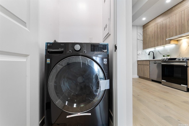 14-54 31st Ave Unit 3A, Astoria, NY 11106 - washroom with washer / clothes dryer, light wood-type flooring, and recessed lighting
