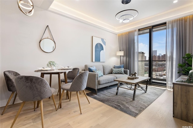 14-54 31st Ave Unit 3A, Astoria, NY 11106 - living room with light wood-style flooring, a view of city, and a raised ceiling